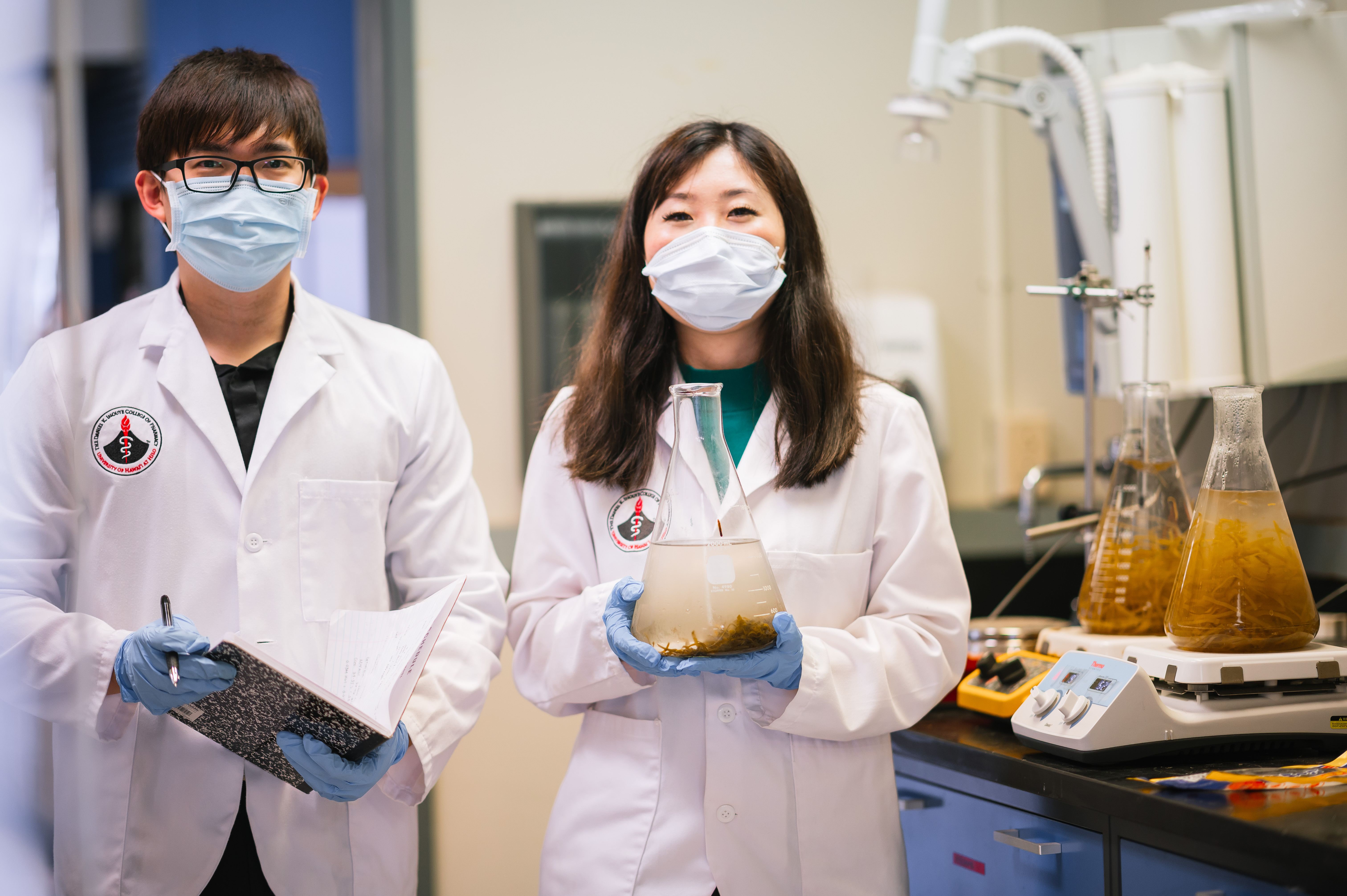 Two students work in a pharmacy research lab